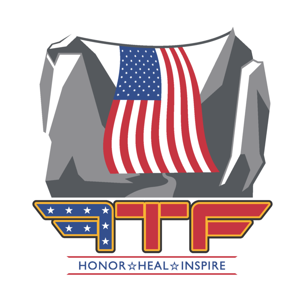 Follow the Flag official logo. Depicts an American flag hanging in a mountain canyon. Below, it says "FTF Honor Heal Inspire"